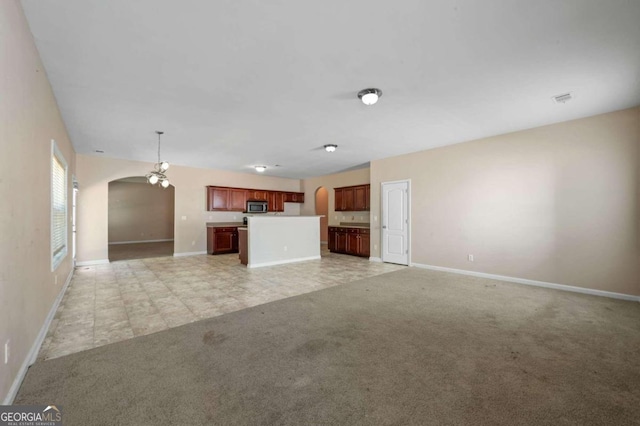 unfurnished living room with light colored carpet