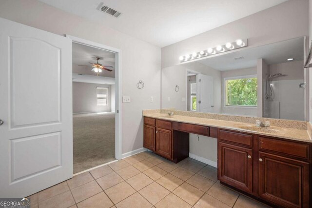 bathroom with tile patterned floors, vanity, walk in shower, and ceiling fan