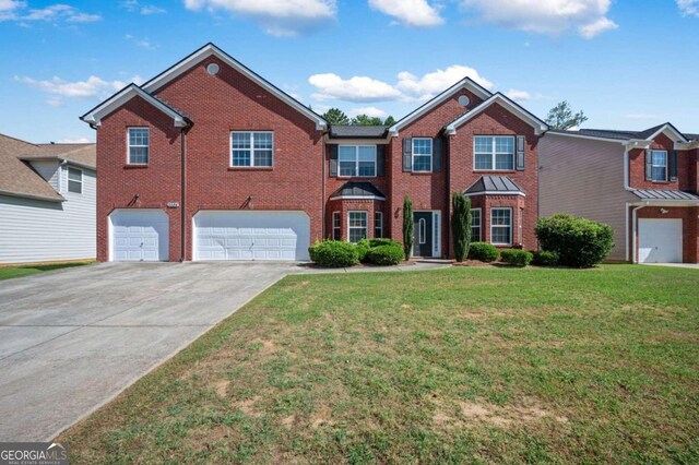 view of front of house with a front lawn and a garage