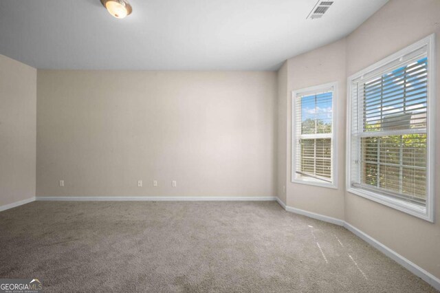 spare room with light carpet