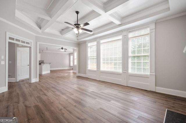 unfurnished living room with ceiling fan, coffered ceiling, hardwood / wood-style floors, ornamental molding, and beam ceiling