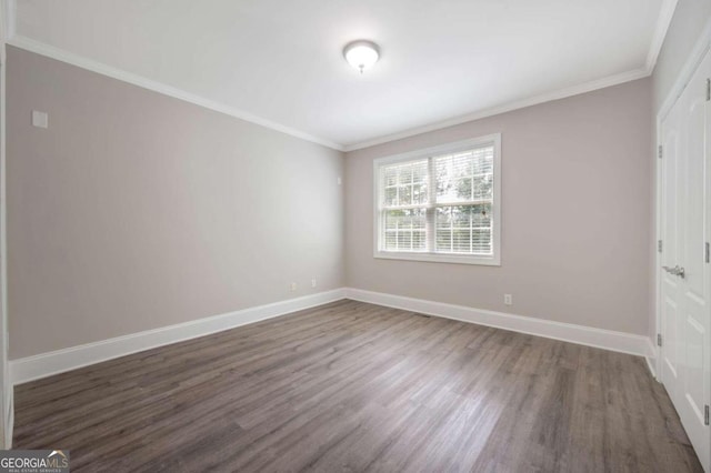 unfurnished bedroom featuring dark hardwood / wood-style floors and crown molding