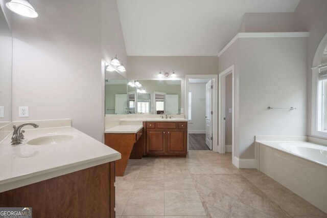 bathroom featuring a bathtub, crown molding, tile patterned floors, and vanity