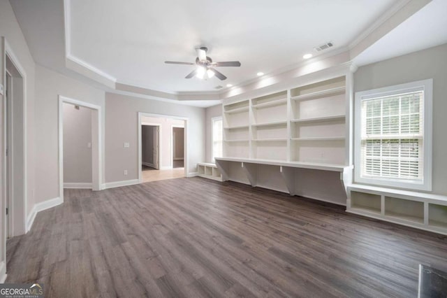 unfurnished living room with ceiling fan, dark wood-type flooring, and a raised ceiling