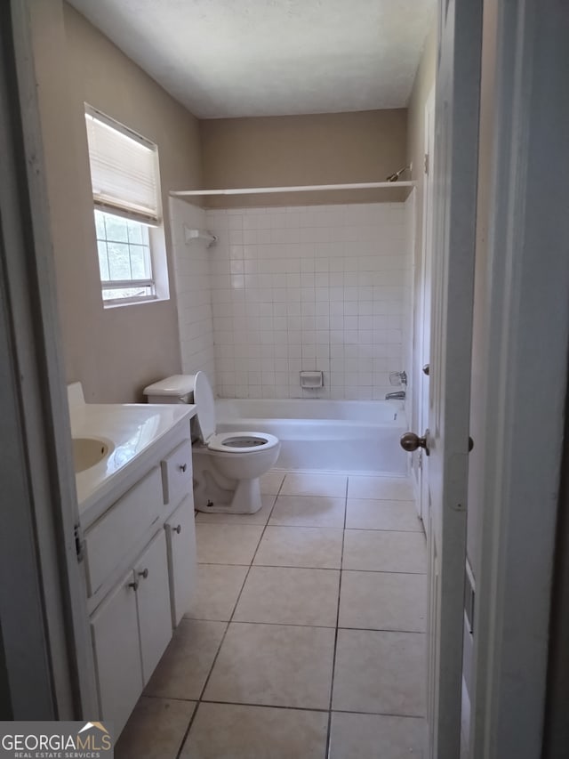 full bathroom with tile patterned flooring, vanity, toilet, and tiled shower / bath combo