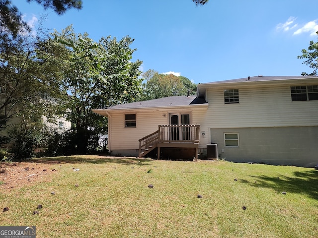 back of house featuring a yard and cooling unit