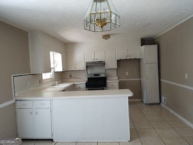 kitchen featuring light tile patterned floors, an inviting chandelier, stainless steel stove, white cabinetry, and decorative backsplash