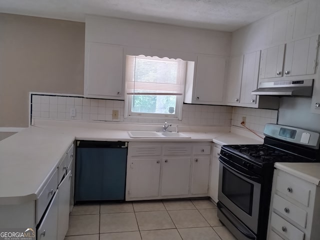 kitchen featuring light tile patterned floors, backsplash, appliances with stainless steel finishes, sink, and white cabinetry