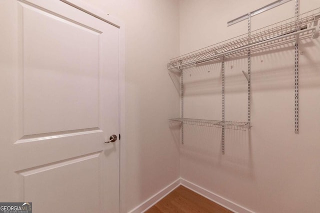 spacious closet featuring hardwood / wood-style flooring