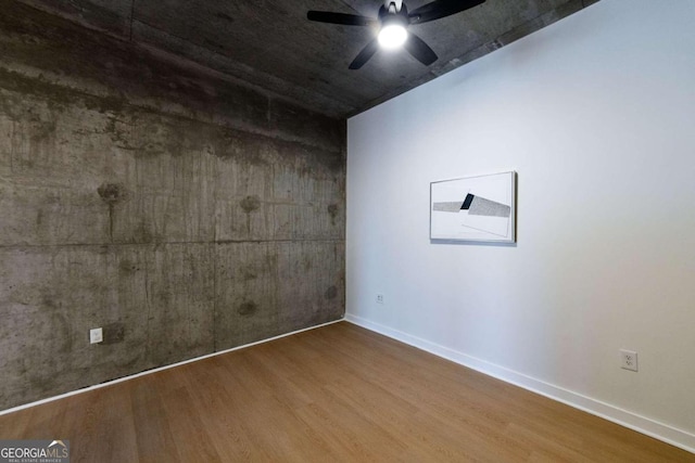 empty room with ceiling fan and wood-type flooring