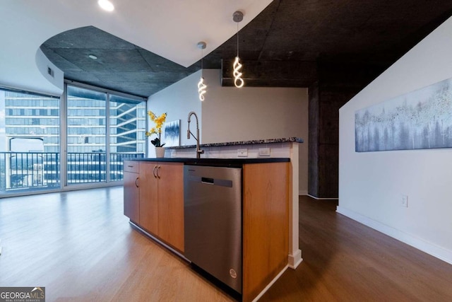 kitchen with expansive windows, pendant lighting, stainless steel dishwasher, and wood-type flooring