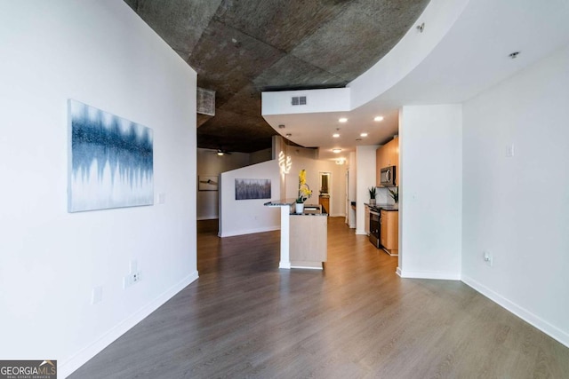 unfurnished living room with dark wood-type flooring