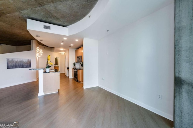 unfurnished living room with hardwood / wood-style floors