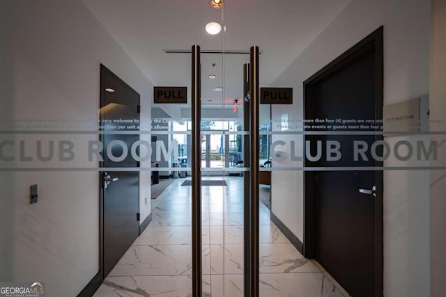 hall with light tile patterned flooring and floor to ceiling windows