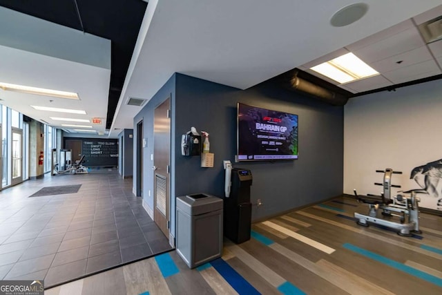 exercise room with tile patterned flooring