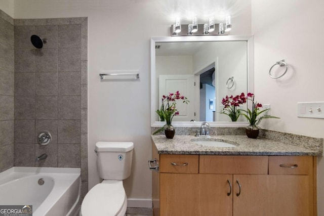 full bathroom featuring toilet, tiled shower / bath, and vanity