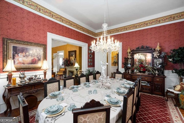 dining space with hardwood / wood-style flooring, crown molding, and a notable chandelier