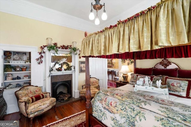 bedroom with ornamental molding and wood-type flooring