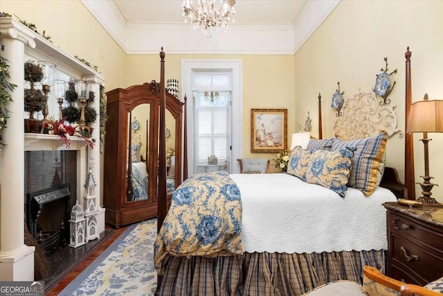 bedroom with a fireplace, a tray ceiling, hardwood / wood-style floors, and an inviting chandelier