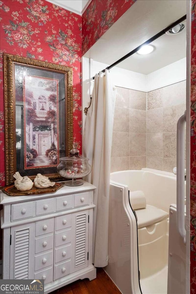 bathroom featuring hardwood / wood-style flooring, shower / bath combo, and vanity