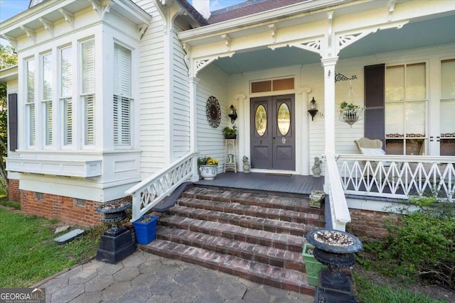 view of exterior entry with a porch