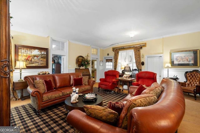 carpeted living room featuring ornamental molding