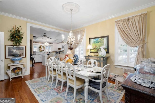 dining area featuring ceiling fan with notable chandelier, dark hardwood / wood-style floors, and ornamental molding