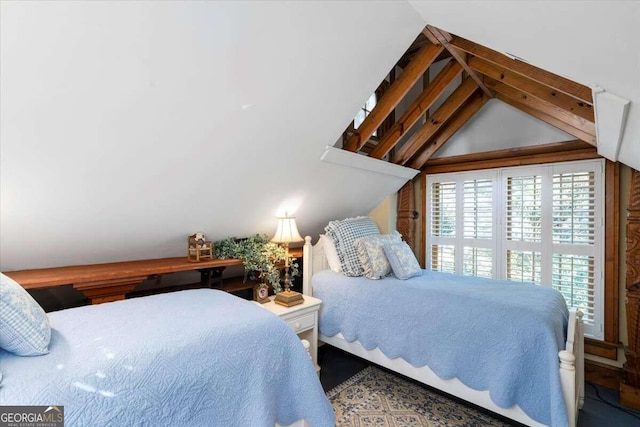 bedroom featuring vaulted ceiling with beams