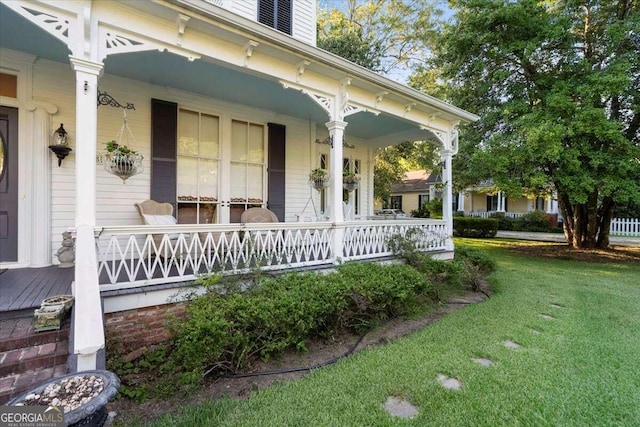 exterior space featuring a lawn and a porch