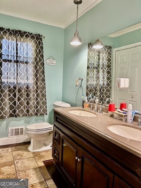 bathroom with tile patterned flooring, toilet, crown molding, and vanity