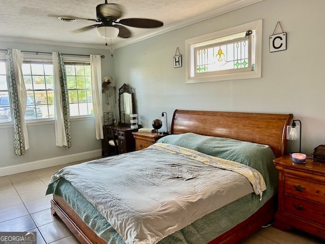 tiled bedroom featuring multiple windows, ceiling fan, and crown molding