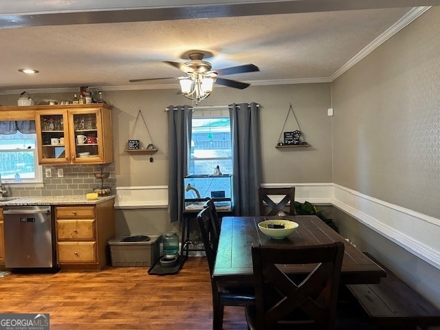 dining space featuring ceiling fan, ornamental molding, and hardwood / wood-style flooring