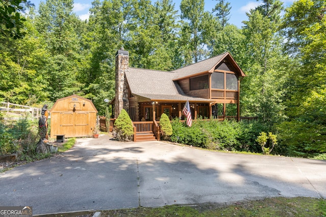 view of front of property with a shed