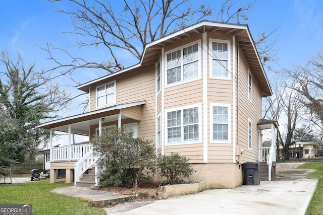 view of side of property with covered porch