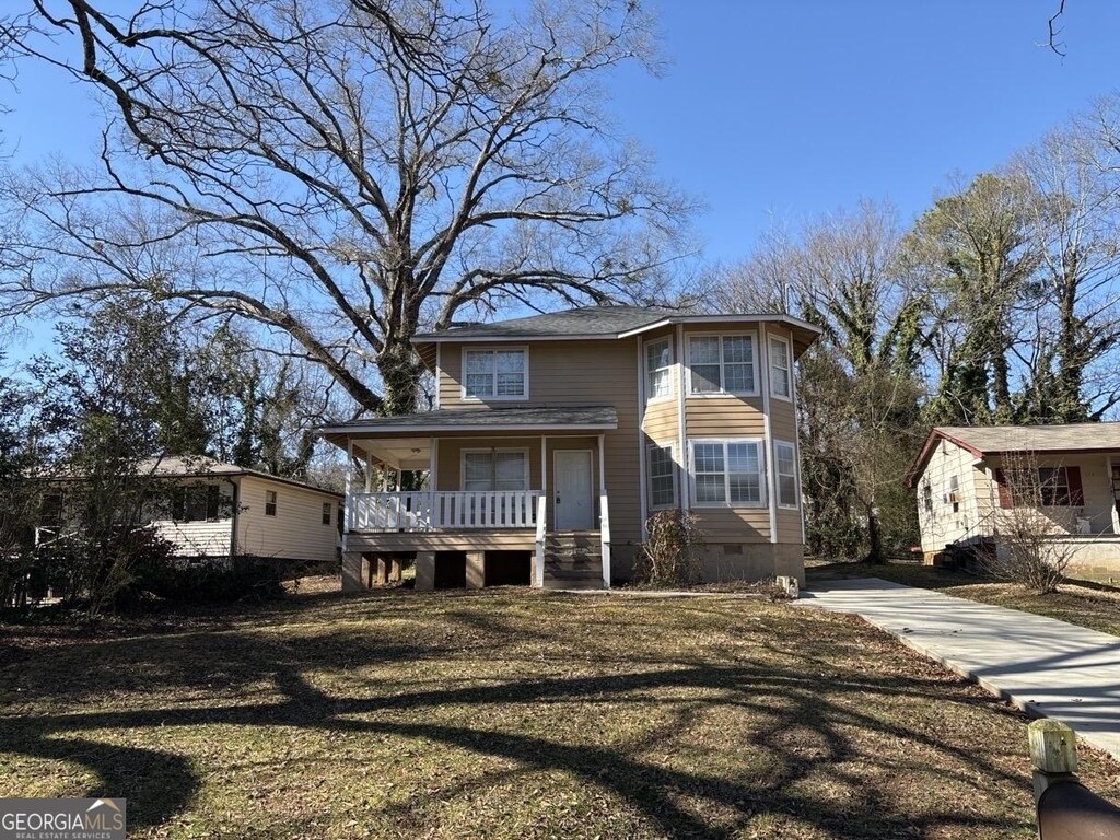 rear view of property with crawl space