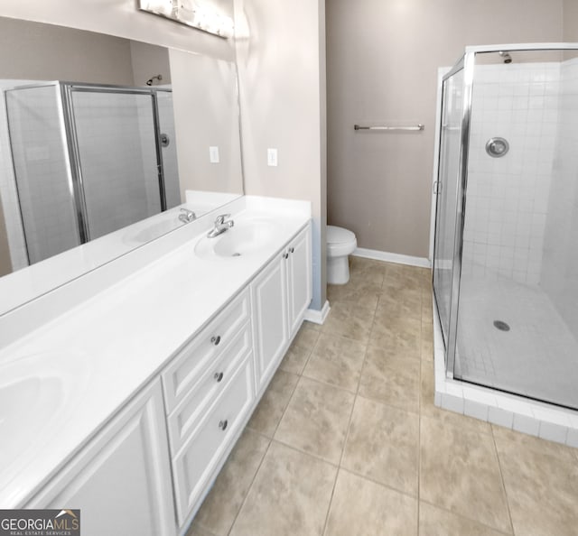 bathroom with vanity, toilet, and an enclosed shower