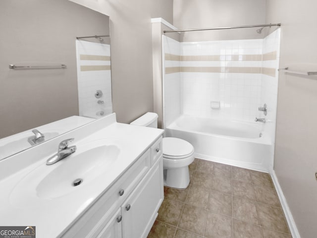 full bathroom featuring tiled shower / bath, vanity, toilet, and tile patterned floors