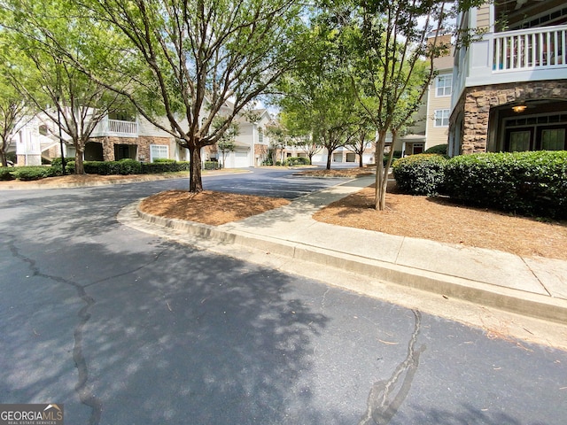 view of road with a residential view and curbs