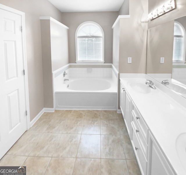 bathroom with a tub, tile patterned flooring, and a healthy amount of sunlight