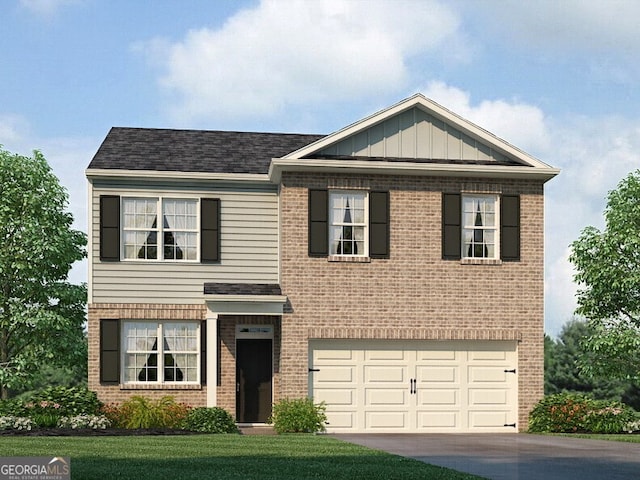 view of front of house featuring a front yard and a garage