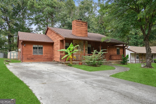 view of front of home with a front yard and a porch