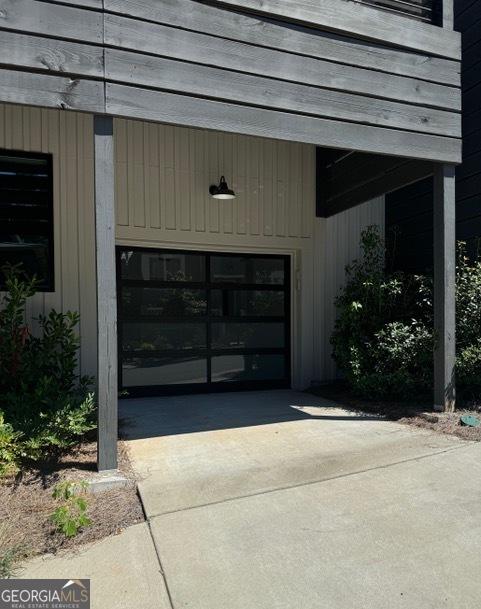 entrance to property featuring a garage and driveway