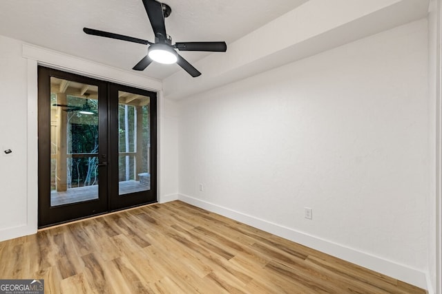 spare room with light hardwood / wood-style flooring, ceiling fan, and french doors