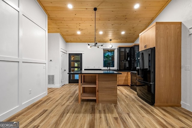 kitchen with black appliances, light hardwood / wood-style flooring, decorative light fixtures, and wood ceiling