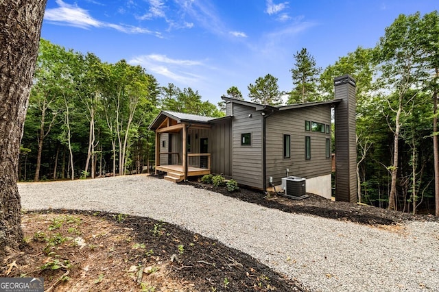 rear view of property featuring central air condition unit