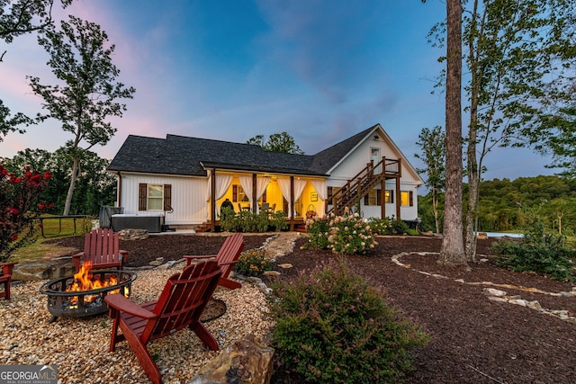 back house at dusk with a fire pit