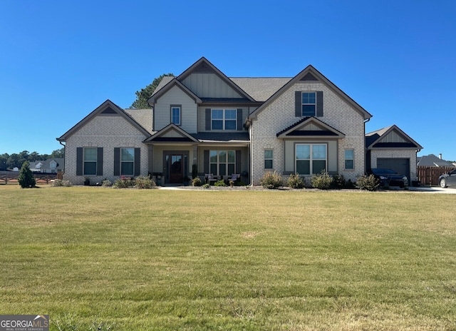 craftsman house featuring a garage and a front lawn