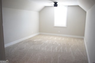 additional living space with light carpet and lofted ceiling