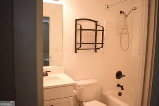 full bathroom featuring vanity, toilet, and washtub / shower combination