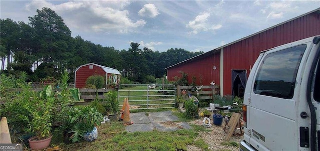 view of yard with fence and an outdoor structure